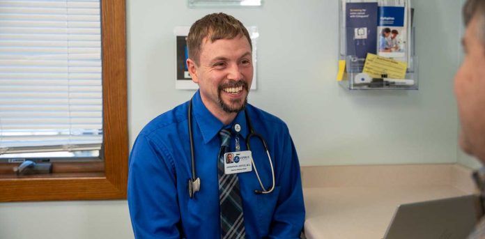 Johnathon-Justice-MD-Aspirus Johnathon Justice, MD, Aspirus Family Medicine Physician meeting with a patient